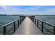 Long wooden dock extending over the calm water at 4575 Cove Cir # 202, St Petersburg, FL 33708