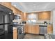 Well-equipped kitchen with stainless steel appliances and light wood cabinets at 4575 Cove Cir # 202, St Petersburg, FL 33708