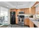 Clean kitchen with stainless steel appliances and ample wood cabinetry at 4575 Cove Cir # 202, St Petersburg, FL 33708