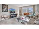 Bright living room with water views, stylish furniture, and hardwood floors at 4575 Cove Cir # 202, St Petersburg, FL 33708