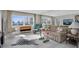 Living room features hardwood floors, large windows, and mid-century modern furniture at 4575 Cove Cir # 202, St Petersburg, FL 33708
