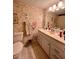 Bathroom featuring a vanity with drawers, toilet and floral wallpaper at 4660 Marine Pkwy # 202, New Port Richey, FL 34652