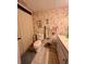 Clean bathroom with floral wallpaper, toilet, and vanity with drawers at 4660 Marine Pkwy # 202, New Port Richey, FL 34652