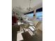 Bright dining area with glass table and four chairs, overlooking a scenic view at 4660 Marine Pkwy # 202, New Port Richey, FL 34652