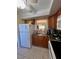 Kitchen with white appliances and view to living area at 4660 Marine Pkwy # 202, New Port Richey, FL 34652