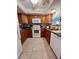 Modern kitchen featuring wood cabinets and granite at 4660 Marine Pkwy # 202, New Port Richey, FL 34652
