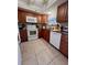 Bright kitchen with wood cabinets and granite countertops at 4660 Marine Pkwy # 202, New Port Richey, FL 34652