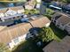 Aerial view of building featuring lush landscaping, private parking, and a serene lake at 4805 Sunnybrook Dr # 21, New Port Richey, FL 34653