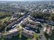 A high aerial perspective showcases the residential neighborhood with lush trees and carport parking at 4805 Sunnybrook Dr # 21, New Port Richey, FL 34653