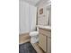 Standard bathroom features a tiled floor, toilet, sink with vanity, and a shower with white curtain at 4805 Sunnybrook Dr # 21, New Port Richey, FL 34653