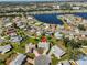 Stunning aerial view of a lakeside community with lush landscaping and well-maintained homes at 502 Lime Tree Ct, Sun City Center, FL 33573