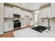 Modern kitchen with white cabinets, stainless steel appliances and quartz countertop at 5825 1/2 S 5Th St, Tampa, FL 33611