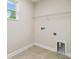 Laundry room with built-in shelving and space for washer and dryer at 5825 1/2 S 5Th St, Tampa, FL 33611