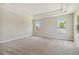 Bright bedroom featuring carpet, large windows, and high ceilings at 5825 1/2 S 5Th St, Tampa, FL 33611
