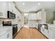 Modern kitchen with white cabinets, stainless steel appliances and quartz countertop at 5825 1/2 S 5Th St, Tampa, FL 33611