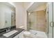 Bathroom with walk-in shower, toilet, and dark vanity at 5825 1/2 S 5Th St, Tampa, FL 33611