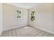 Well-lit bedroom with new carpet and two windows at 5825 1/2 S 5Th St, Tampa, FL 33611