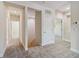 Upstairs hallway with carpet, access to bedrooms and stairs at 5825 1/2 S 5Th St, Tampa, FL 33611
