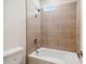 Bathroom with tub and shower, tile surround, and new fixtures at 5825 1/2 S 5Th St, Tampa, FL 33611