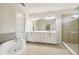 Double vanity bathroom with a large shower and soaking tub at 5825 1/2 S 5Th St, Tampa, FL 33611