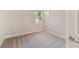 Cozy bedroom with carpet, window, and door to hallway at 5825 1/2 S 5Th St, Tampa, FL 33611