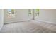 Well-lit bedroom with neutral carpeting and window views at 5825 1/2 S 5Th St, Tampa, FL 33611