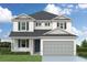 Two-story house with gray garage door and shutters at 5825 S 5Th St, Tampa, FL 33611