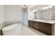 Modern bathroom featuring a stand-alone tub, double vanity sinks, and a walk-in shower at 5825 S 5Th St, Tampa, FL 33611