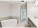 This bathroom offers a stand-alone tub, double vanity sinks, and a walk-in closet at 5825 S 5Th St, Tampa, FL 33611