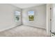 Bright bedroom with two windows featuring views and neutral carpeting at 5825 S 5Th St, Tampa, FL 33611