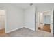 Neutral carpeted bedroom with an open door to other rooms at 5825 S 5Th St, Tampa, FL 33611