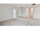Bright and airy bedroom featuring neutral carpeting, multiple doorways, and ample space at 5825 S 5Th St, Tampa, FL 33611