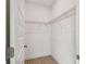 Compact closet featuring metal shelving, neutral carpeting and a white interior at 5825 S 5Th St, Tampa, FL 33611
