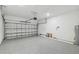 Spacious garage with epoxy flooring, overhead lighting, and an insulated garage door at 5825 S 5Th St, Tampa, FL 33611