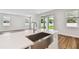 Bright kitchen with stainless steel sink, quartz countertop, and sliding glass door to the backyard at 5825 S 5Th St, Tampa, FL 33611