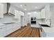 Modern kitchen featuring white cabinets, stainless steel appliances, and wood flooring at 5825 S 5Th St, Tampa, FL 33611