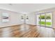 Spacious living room with hardwood floors and sliding glass doors to the backyard at 5825 S 5Th St, Tampa, FL 33611