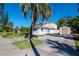 Home with a spacious backyard, storage shed, and palm trees at 603 Virginia Ave, Tarpon Springs, FL 34689