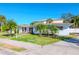 House exterior showcasing a single-story home with palm trees and a well-maintained lawn at 603 Virginia Ave, Tarpon Springs, FL 34689