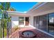 Exterior view showing a home's entrance with a red brick patio and fountain at 603 Virginia Ave, Tarpon Springs, FL 34689