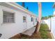 White home with a side yard, palm tree, and access door at 603 Virginia Ave, Tarpon Springs, FL 34689
