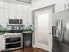 Modern kitchen with stainless steel appliances and green tile backsplash at 760 Coral Reef Dr, Tampa, FL 33602