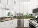 Modern kitchen with white cabinets, granite counters and stainless steel appliances at 760 Coral Reef Dr, Tampa, FL 33602