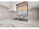 Bright kitchen with white cabinets and a double sink at 35209 Ada Ave, Zephyrhills, FL 33541