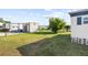 Backyard with grass and additional structures at 35209 Ada Ave, Zephyrhills, FL 33541