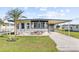 Single-Gathering home with carport and landscaped yard at 35209 Ada Ave, Zephyrhills, FL 33541