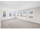 Spacious living room with light gray walls and carpeting at 35209 Ada Ave, Zephyrhills, FL 33541