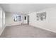 Spacious living room featuring neutral carpeting and large windows at 35209 Ada Ave, Zephyrhills, FL 33541