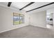 Spacious living room with exposed beams and carpeted floors at 35209 Ada Ave, Zephyrhills, FL 33541