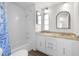 Bright bathroom with a shower/tub combo, vanity, and mirror at 35209 Ada Ave, Zephyrhills, FL 33541